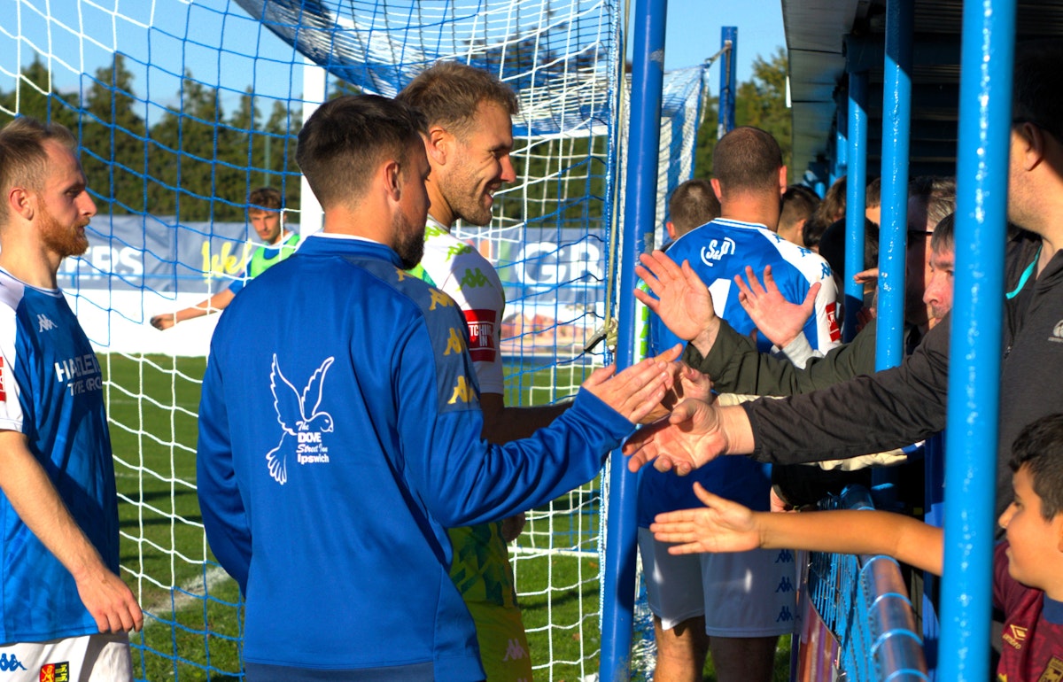 Players celebrate with fans at the end of the game